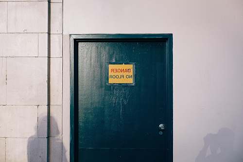 united states blue wooden door with gold and black signage door